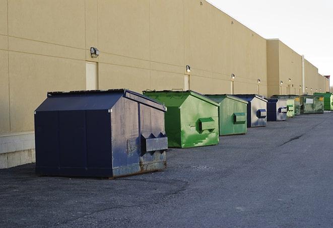 a series of colorful, utilitarian dumpsters deployed in a construction site in Arlington, TX